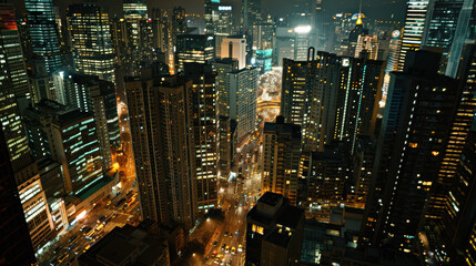 Night in the big city, with illuminated skyscrapers and busy traffic on the streets below.