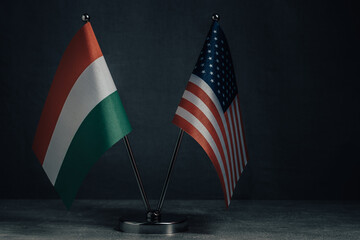 Table flag United States America and National Flag Hungary on dark background.