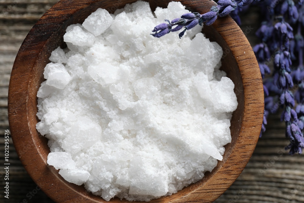 Poster Natural sea salt in bowl and lavender on table, top view