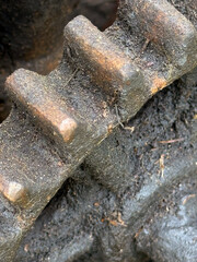 Transmission mechanism of a manual animal feed grinder. Gears of an old chaff cutter. Covered in used oil and dust. Close up.