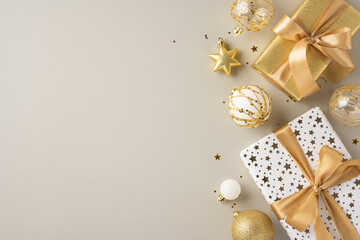 Luxurious Christmas presents wrapped in gold and white with elegant decorations. Perfect for...