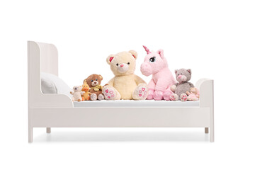 Soft stuffed animals plush toys on a kids bed