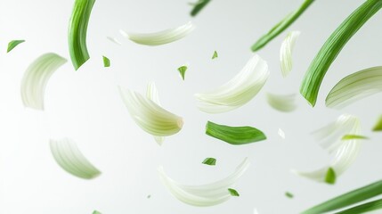 Obraz premium Falling green onion slices suspended in air on a white background perfect for food preparation or ingredient-themed projects.. Generative AI