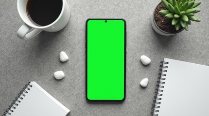 A smartphone with a bright green screen lies flat on a grey concrete surface