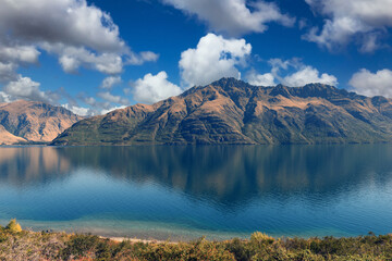 panoramic scenic view of Lake Wakatipu with mountains in the background near Queenstown, South Island, New Zealand
