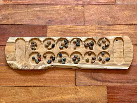 Handcrafted Wooden Mancala board with Colorful Stone Seeds - A boardgame of Arab, Muslim, African, and Asian Heritage Spread Through Migration