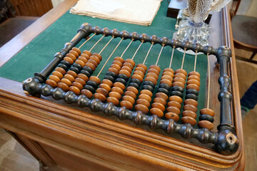 Old abacus, counting frame lies on the table in office