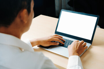 Business person or office worker using laptop computer while sitting at desk. uds