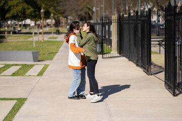 Lesbian about to kiss in a park