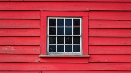 Fototapeta premium Closeup of window on a striking red clapboard building