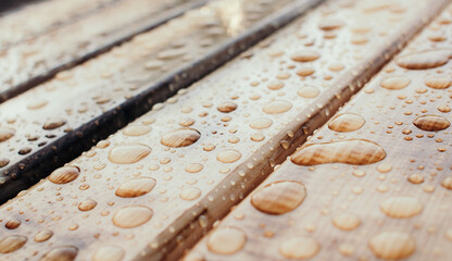 Water drops pattern on wooden material. Tinted colors. Shallow depth of field.