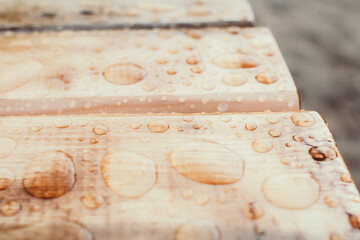 Water drops pattern on wooden material. Tinted colors. Shallow depth of field.
