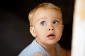 face of little boy looking up with big eyes, portrait of cute child