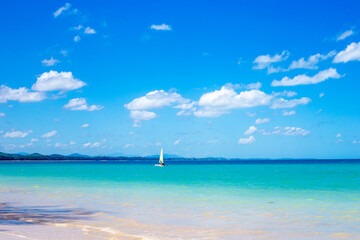 Beautiful seascape. Blue sky and sailboat in the sea. Idyllic seaside vacation