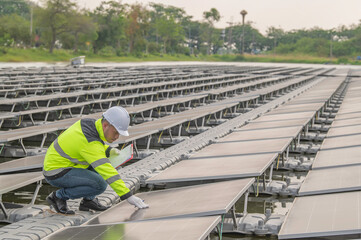 Engineer working at floating solar farm,checking and maintenance with solar batteries near solar panels,supervisor Check the system at the solar power station