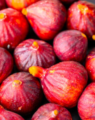 Figs close-up. Heap of figs, whole fruits and cut in half. Sweet exotic fruit for dessert, healthy food.
