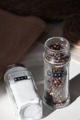 Minimalist Salt Shaker and Pepper Grinder in Natural Light Stock Photo