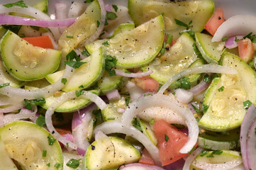 healthy food dish with salad greens vegetables seasoned salad vegan lunch tomato and onion green zucchini