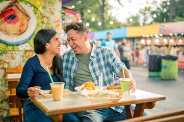 Fototapeta premium Friends share food, talk and laugh with great joy.