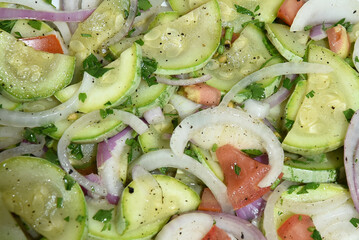 healthy food dish with salad greens vegetables seasoned salad vegan lunch tomato and onion green zucchini