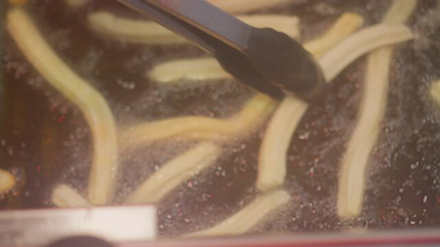Churros that get turned in hot oil while baking