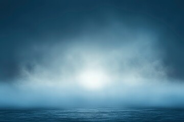 Obraz premium A Foggy Sea Horizon with a Glimmering Light Source