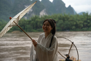 Happy Hanfu Woman smiles and thumbs up by Li River. China, 4K