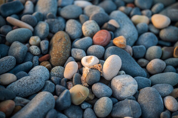 A beach with rocks and pebbles, and small stones up close.