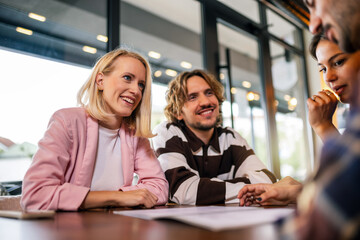 Friends looking at the menu in the restaurant choosing what to eat.