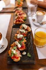 Canape served as appetizer on a gathering in a restaurant. Food and drink concept.