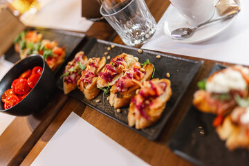Canape served as appetizer on a gathering in a restaurant. Food and drink concept.