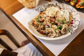 Tasty meat in creamy sauce with mashed potatoes and vegetables. Food and drink concept.