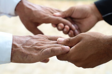 Two boys are holding each other's hands