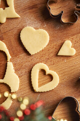Fototapeta premium Heart shapes cut out from rolled out pastry dough to prepare traditional Linzer Christmas cookies, top view