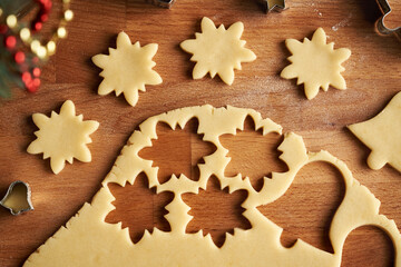 Cutting out star shapes from rolled out pastry dough - preparation of traditional Linzer Christmas cookies