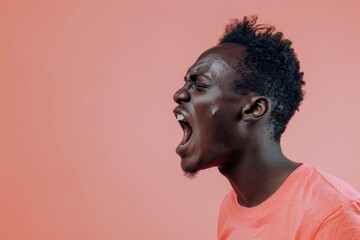 Obraz premium Unhappy African man jumping with anger on pink background.