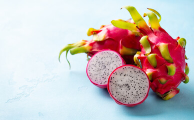Asian exotic Dragon fruit, pitahaya. Blue background. Close up. Copy space.