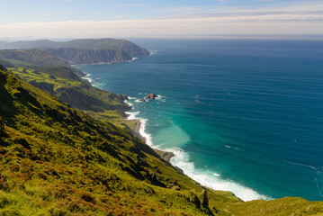 green mountains under blue sky over ocean coast, beautiful nature landscape