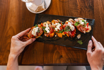 Canape served as appetizer on a gathering in a restaurant. Food and drink concept.