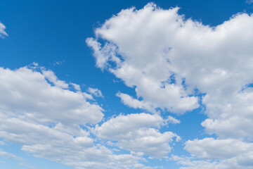 Blue Sky with Fluffy White Clouds on a Sunny Summer Day. Cloudscape - Blue sky and white clouds. Background cloud summer. Sky cloud clear with sunset. Natural sky