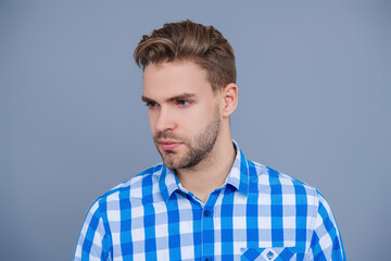 Fototapeta premium Young millennial man isolated on grey. Stylish man face portrait. Casual style of man. Guy has stylish haircut. Man with trendy hairstyle. Casual male style portrait. Millennial portrait