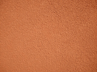 Bright orange painted plaster wall texture