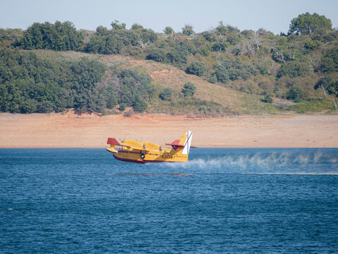 Ponferrada, Leon, Spain; 09-17-2024: Canadair CL-215 seaplane from the 43rd Air Force Group begins the climb maneuver after collecting water from the reservoir to extinguish the Bra&ntilde;uelas fire