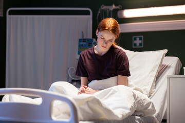 Taking a moment of rest during her hospital visit, the red-haired patient.