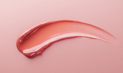 A tube of lip gloss is shown with a pink lip gloss color