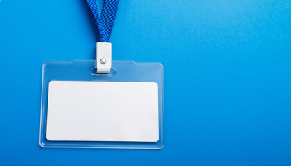 Obraz premium Blank office badge, empty name tag on bright blue backdrop. Mock-up.