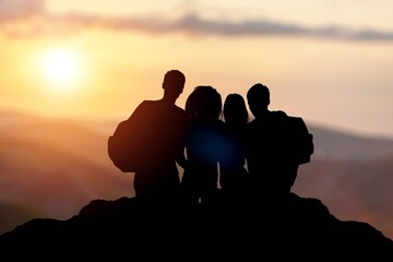 Big group of happy young tourists at mountain top.