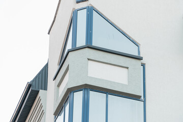 Modern architectural design showcasing a sleek glass corner of a contemporary building