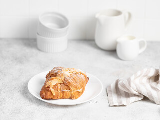 Almond Croissant pastry on a light table. Bright mood style. Perfect for recipe, article, catalogue. 
