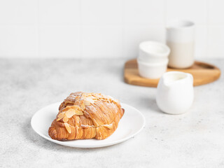 Almond Croissant pastry on a light table. Bright mood style. Perfect for recipe, article, catalogue. 